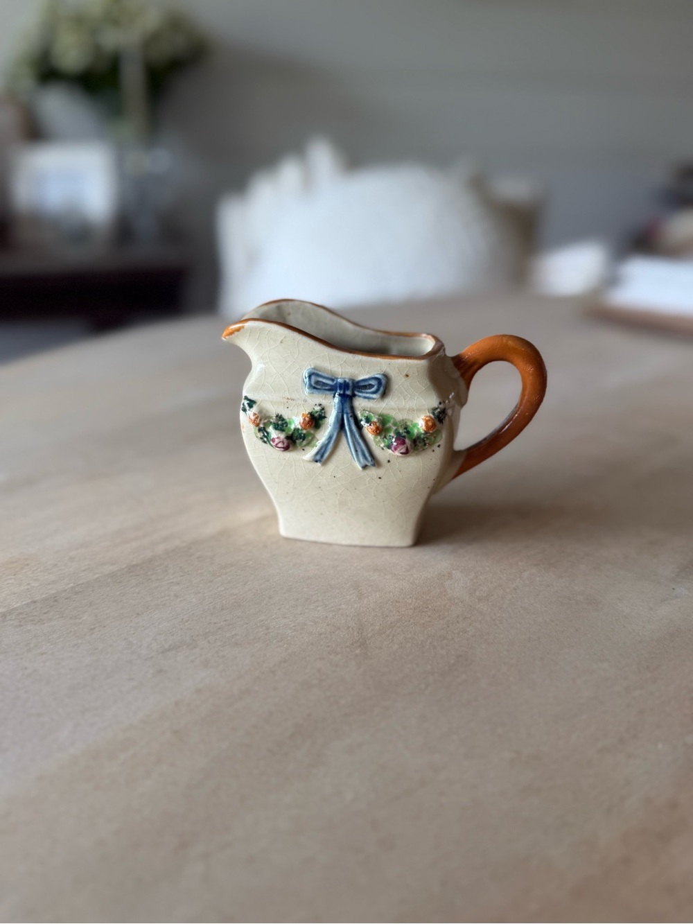 Vintage hand-painted ceramic creamer pitcher with floral and ribbon motif